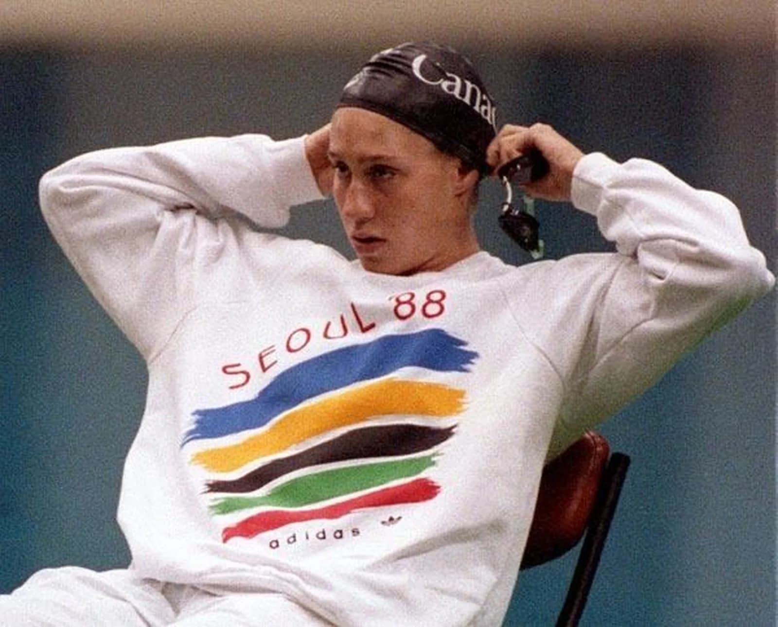 Allison Higson at the Seoul 1988 Olympic Games, age 15, wearing the Adidas SEOUL 88 sweatshirt and Canada cap, where she finished 7th in the 200m breaststroke and won bronze in the 4x100 medley relay